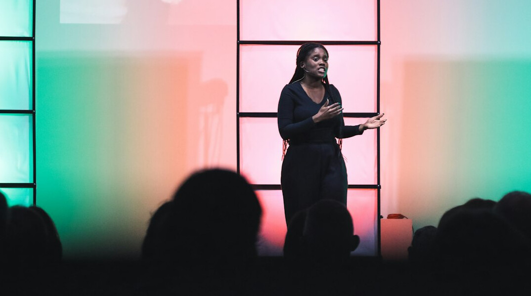 woman speaking confidently on stage