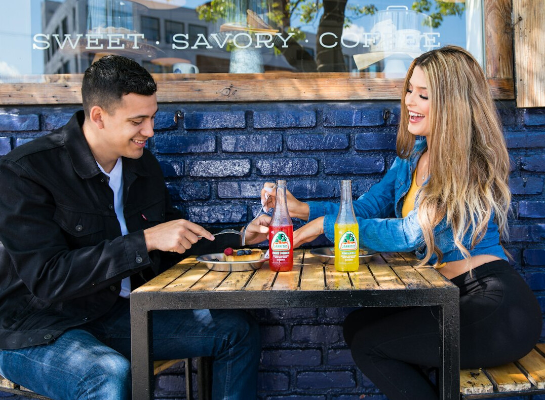 Two colleagues having a calm supportive conversation at a cafe table