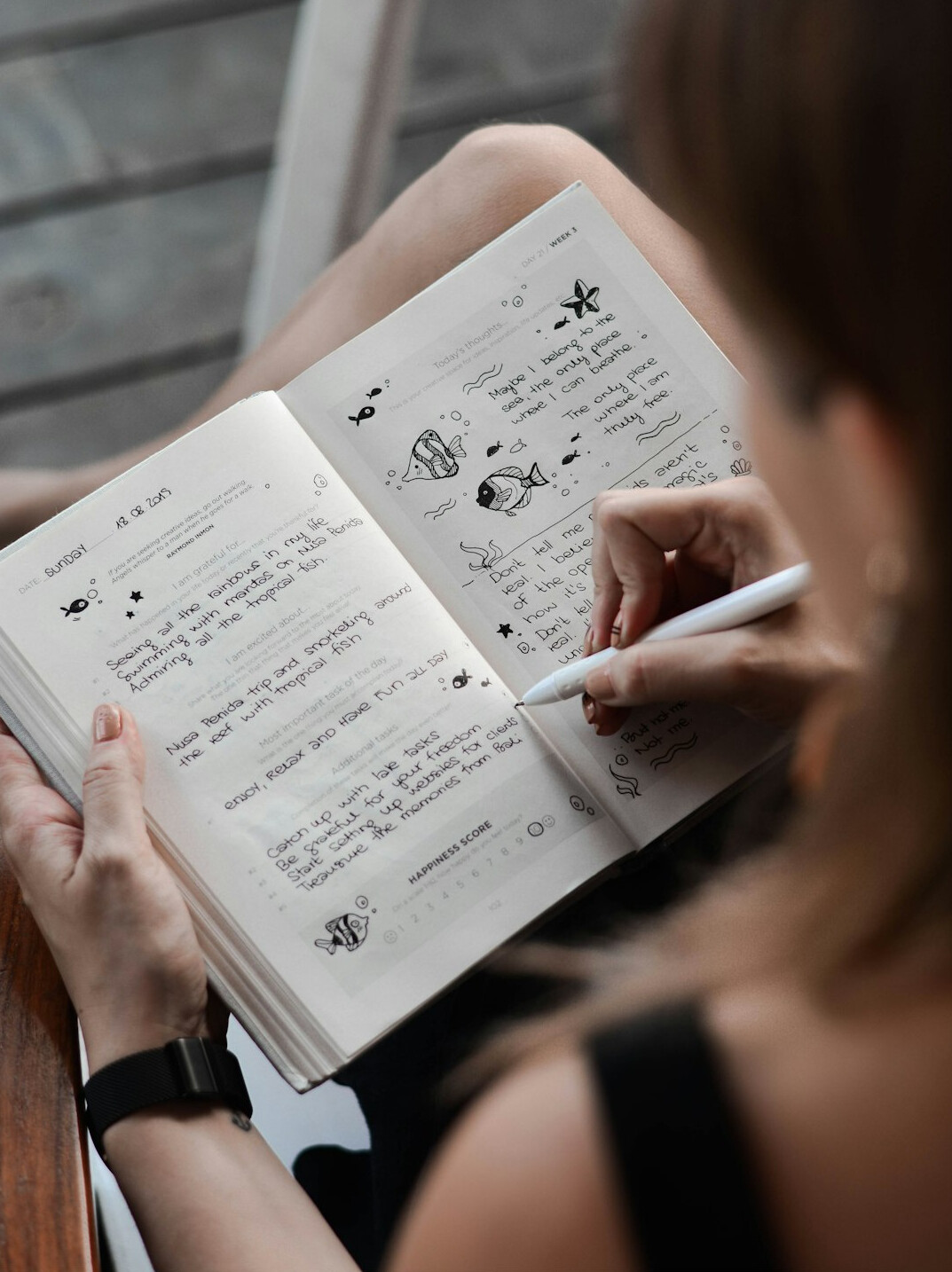 person writing in journal